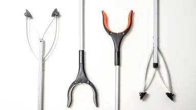 Four different reacher grabber tools on a white background