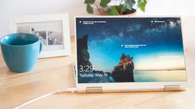 The laptop is set up as a tablet, with the keyboard used as a stand.