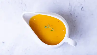A gravy boat filled with gravy, shot from above