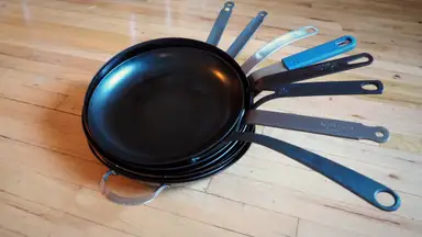 A stack of the best carbon steel pans Reviewed tested from Mauviel, BK Cookware, Blanc Creative, Matfer Bourgeat, De Buyer Mineral B, and more.