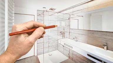 An architect draws plans for a bathroom renovation
