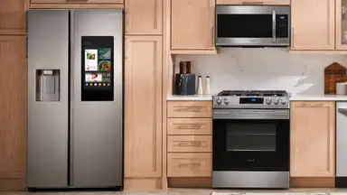The Samsung RS27T5561SR Side-by-Side Refrigerator in a modern kitchen, alongside other Samsung kitchen appliances.