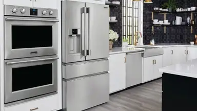 The Frigidaire Pro PRMC2285AF counter-depth French-door refrigerator, set up in a fancy kitchen alongside many other Frigidaire appliances.