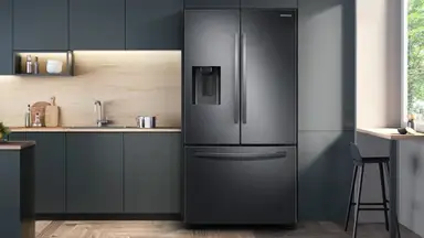 An image of the front of the Samsung RF27T5201SG French door refrigerator in a modern kitchen.