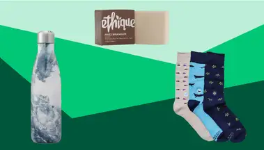 A S'well water bottle, shampoo bar, and three pairs of socks on a green background
