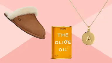 A slipper, olive oil, and pendant on a pink background