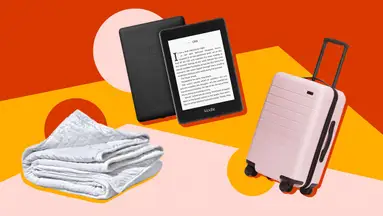 gravity blanket, e-reader and pink suitcase on colorful background