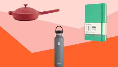 Skillet, water bottle and notebook on colorful background