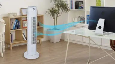 A tower fan providing ventilation in a home office space.