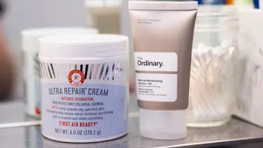 A jar and tube of moisturizer next to each other on a shelf.