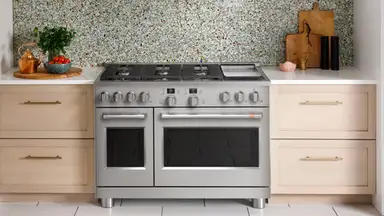 The GE Cafe C2Y486P3TD1 Gas Range hooked up in place inside a kitchen.