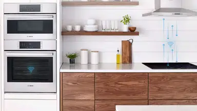 Stainless steel top and bottom Bosch ovens in kitchen.