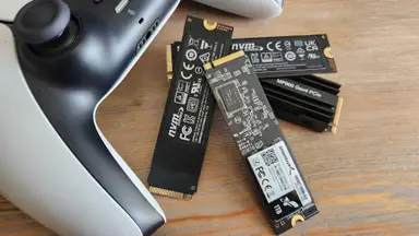 A collection of M.2 SSDs next to a gaming controller