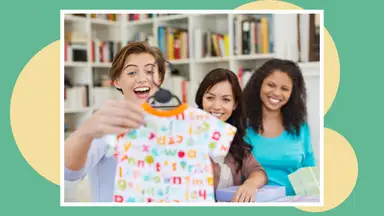A woman enjoys a baby registry gift with her friends.