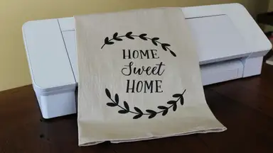 A Sillhouette printer with a bag on top.