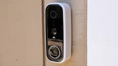 Abode Wireless Video Doorbell mounted on outside of home.