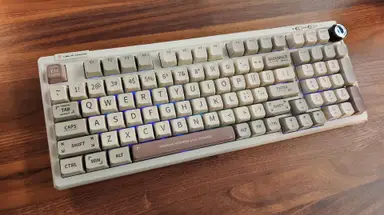 The Epomaker RT100 Mechanical Keyboard with the RGB keys on laying flat on a table.