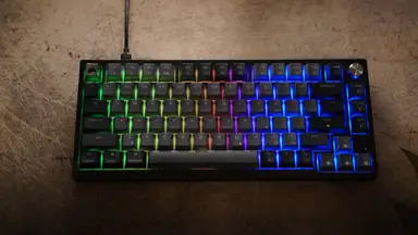 The Corsair K65 Plus Wireless lit up in RGB lights.