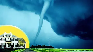 A white-colored home in front of a yellow, circular background opposite a large tornado