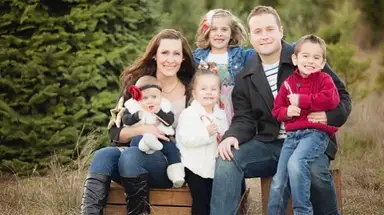 A large family taking a photo for their Christmas card.