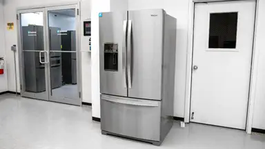 A wide shot of the Whirlpool WRF767SDHZ French-door refrigerator sitting outside our fridge testing labs.