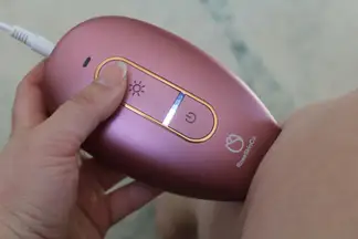 The RoseSkinCo Lumi permanent hair removal device being used on someone’s leg.