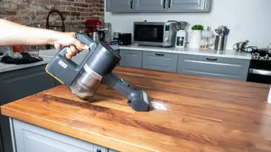 The LG Cordzero A949KTMS cleaning sugar off a countertop