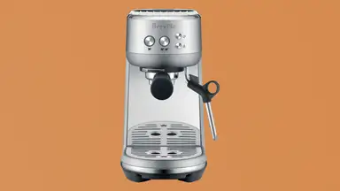 Breville Bambino espresso maker on brown paper-like background
