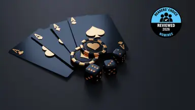 black and gold cards, casino chips, and dice on a black background