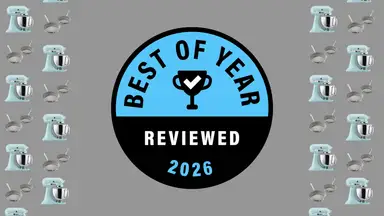 Reviewed's Best of Year Award badge on a gray background with pans and stand mixers