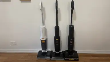 Roborock F25 Series Wet-Dry Vacuums stand against a wall in a residential hallway
