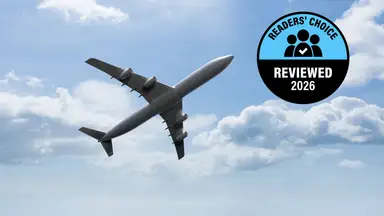Airplane flying through the sky with a Reviewed Readers' Choice 2026 badge displayed.