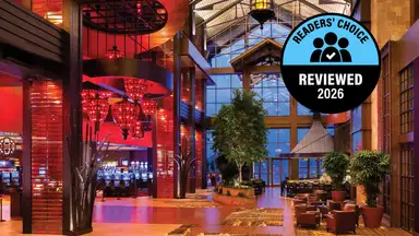 A hotel lobby with red lights and an award badge on the photo