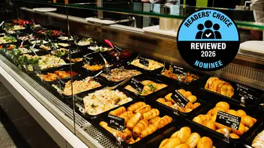 A prepared foods counter with trays of salads, pastries, and rice dishes, with a "Readers' Choice Reviewed 2026 Nominee" badge.
