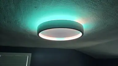 Govee Sky Ceiling Light glowing turquoise on a ceiling.