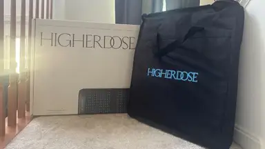 HigherDOSE PEMF Go Mat case sits on stairs with box nearby