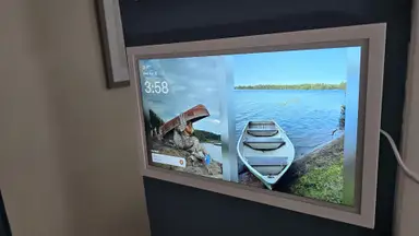 Greenlight Family Hub mounted on wall, displaying photos on screen.