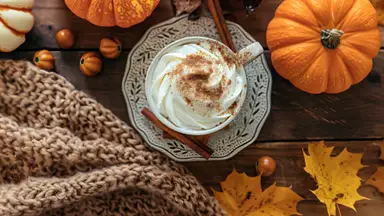 Pumpkins, leaves, a coffee cup, and a blanket