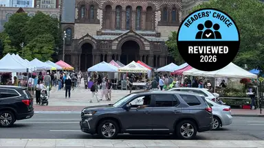 A farmers market stands in front of a brown church landmark in Boston