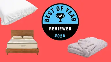 Pillow, bed, and blanket shown on red background with Reviewed's blue and black Best of Year Badge in the center.