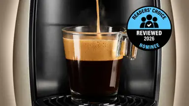 A rich cup of coffee is being brewed