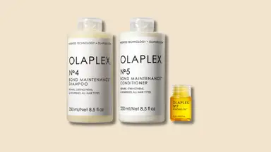 The Olaplex Wash & Shine Hair Kit, including No. 7 Bonding Oil, No. 4 Bond Maintenance Shampoo, and No. 5 Bond Maintenance Conditioner on a beige background.