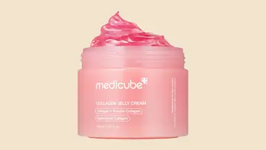 Pink Medicube Collagen Jelly Cream container against a tan background.