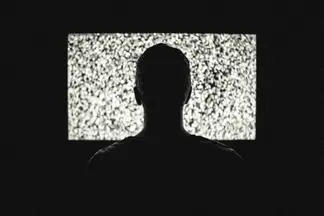 Guy watching fuzzy TV