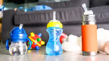Straw cups for toddlers on a table.