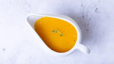 A gravy boat filled with gravy, shot from above