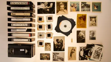 A collection of old VHS tapes, black and white photos, and slides.