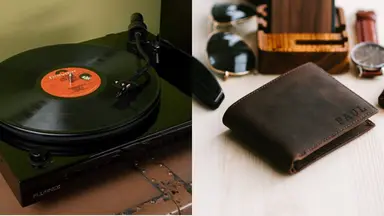 Record player displayed on table and brown leather wallet sitting amongst personal items.