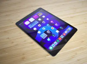 A computer tablet face up on a desk
