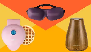 Pink waffle maker, purple eye mask, wooden design air purifier on yellow/orange background